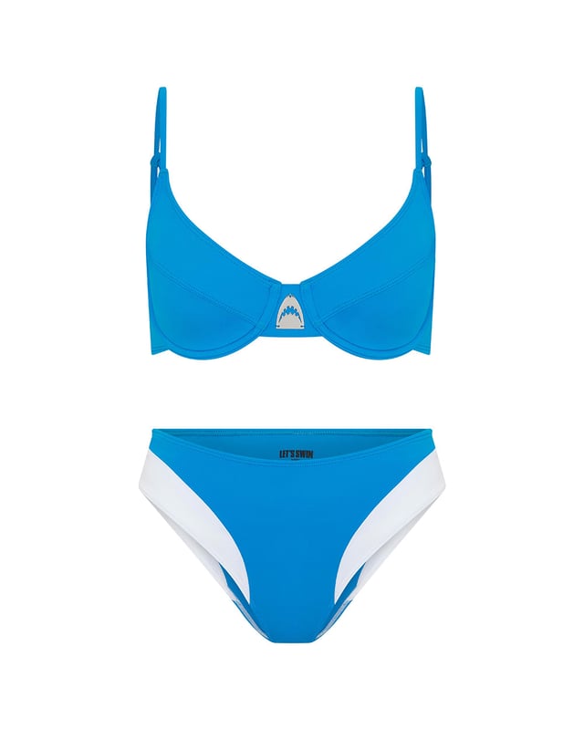 Our signature LET'S SWIM shark logo takes centre stage on this bikini top. Presented in oceanic blue, it combines style and function with its unique balconette silhouette, offering fuller coverage and wired support. Whether you're catching waves or sun rays, this top empowers strength and confidence with every wear. Pair with the matching hipster bikini bottom to complete the ensemble.