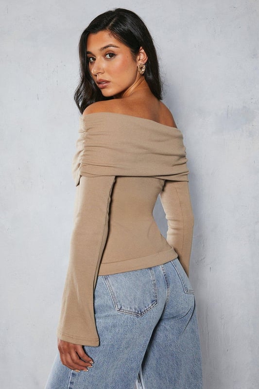 Bardot off-shoulder neckline
Long sleeves with ribbed texture  
Form-fitting stretch jersey fabric
Straight hem cut

This on-trend bardot top from Misspap features an alluring off-shoulder design with long sleeves. Crafted from a soft stretch jersey fabric with a body-hugging fit, it flatters the figure beautifully. The ribbed texture adds visual interest. Pair this versatile top with high-waisted jeans or a skirt for a chic day or night look. It works well layered under leather and denim jackets too. The fold-over bardot neckline is perfect for showcasing dainty necklaces. For a going-out look, style with heels and statement earrings to be the centre of attention. This top transitions seamlessly from casual daywear to evening cocktails.