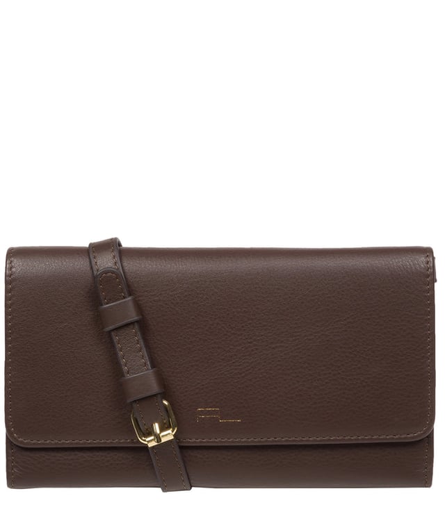 The 'Saffron' cross body clutch bag from the Pure Luxuries Marylebone collection is handcrafted from high-quality, genuine Nappa leather with a natural super-soft touch. The minimalistic fold-over top is secured by a gold-coloured magnetic press stud. The interior is lined with 100% cotton and features slip pockets and card slots to help keep an organised bag. Comes with an adjustable slim leather strap with a maximum drop length of 65cm. The strap is also removable by releasing the two interior press studs, transforming the bag into a clutch bag. Furnished with gold-coloured metal fittings. The minimalist Pure Luxuries logo is embossed in gold foil for a beautifully simple finishing touch.