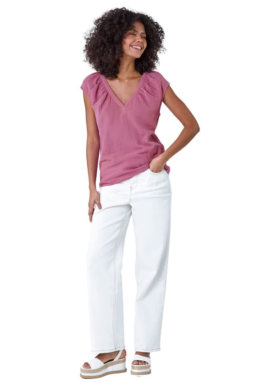 V-Neck Pleat Detail Cotton Top from Roman. Elevate your Summer basics with this breezy v-neck tee! Crafted from cooling cotton, this sleeveless top features a chic v-neckline completed with pleating for a touch of subtle sophistication. Perfect for casual outings, this t-shirt pairs effortlessly with wide-leg trousers and sandals for timeless Summer style.
