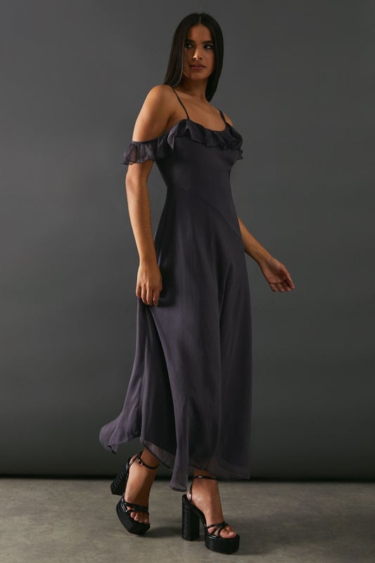 Add a touch of elegance to any occasion. With its embellished asymmetric ruffle and strappy design, it offers a unique and stylish look. The midaxi length adds a modern twist, making it perfect for both casual and formal events.