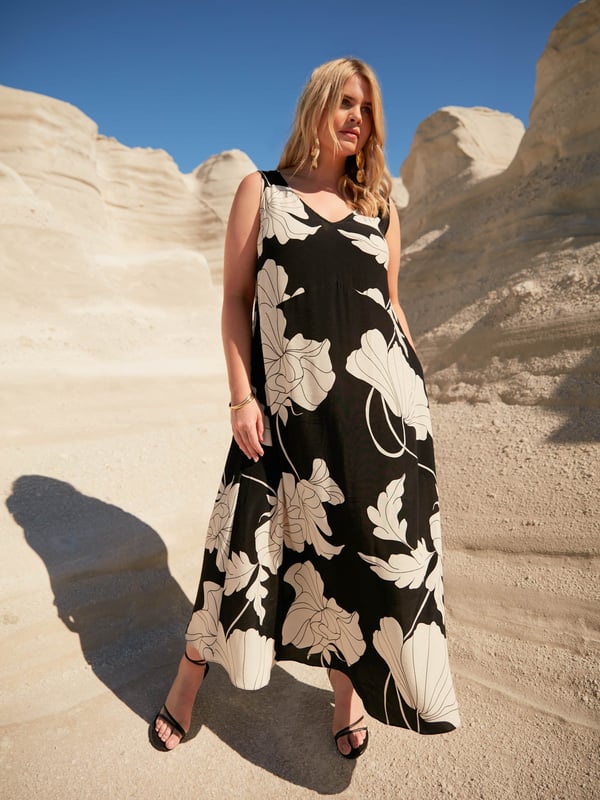 Printed all over with a monochrome floral print, this maxi dress is cut from a woven fabric thats very breathable and moves beautifully. With a sleeveless body and a lengthening V-neckline, it has a loose, flowing shape which is endlessly flattering. Dress this up or down, depending on your plans.