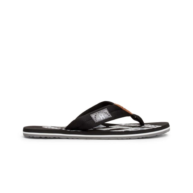 Mens Tommy Hilfiger Essential Beach Flip Flops in black.- Synthetic upper.- Slip on design.- Branded retro graphics.- Synthetic lining.- Rubber sole.- Ref.: FM0FM01369990