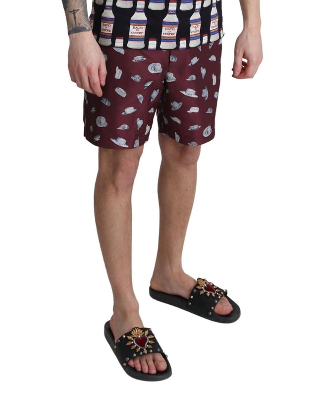 Absolutely stunning 100% Authentic exclusive brand new with tags
  Dolce &amp; Gabbana Beachwear swimming trunks
  2 inset front pockets
  1 zip rear pocket with hats print
  Modell: Swimshorts Trunks Boxer
  Color: Maroon
  Material: 100% Polyester
  Elastic waist strap
  Two front pockets and one back pocket
  Logo details
  Great fitting and comfort
Material: 100% Polyester