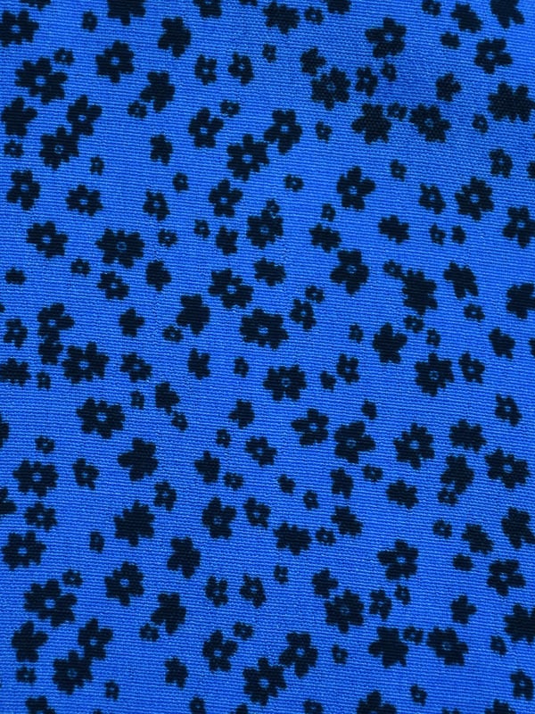 Printed all over with a beautiful blue ditsy print, this dress is cut from a soft woven fabric that moves beautifully. With a flattering tiered shape, it has a button-through front and an elasticated waistband to ensure the perfect fit. Voluminous sleeves add to its elegant silhouette, making it the perfect dress to elevate your everyday.