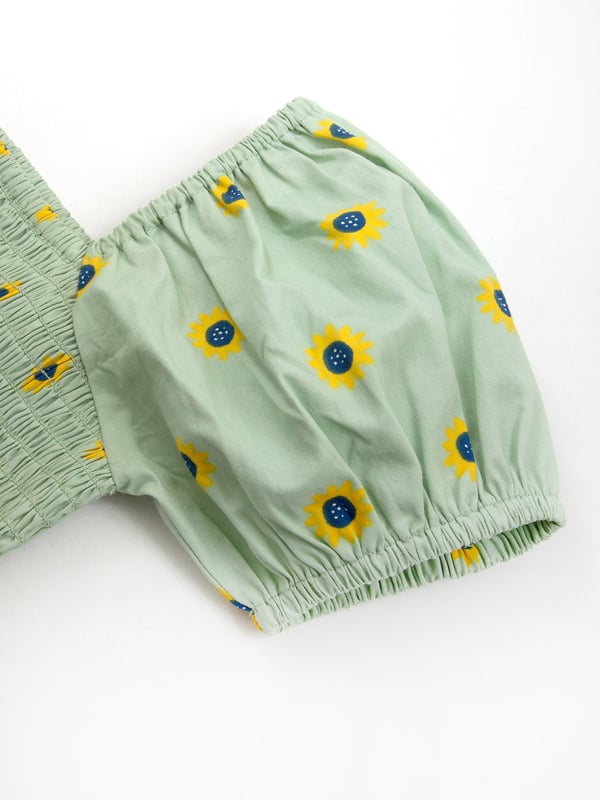 100% organic cotton | Proud to be certified to the Global Organic Textile Standard (GOTS) | Sunflower dot all-over print | Soft sage | Poplin fabric | Elasticated short sleeves | Square neck | Elasticated shirring at chest | Made in India | Machine washable at 40 degrees, or at 30 degrees to be kinder to the planet