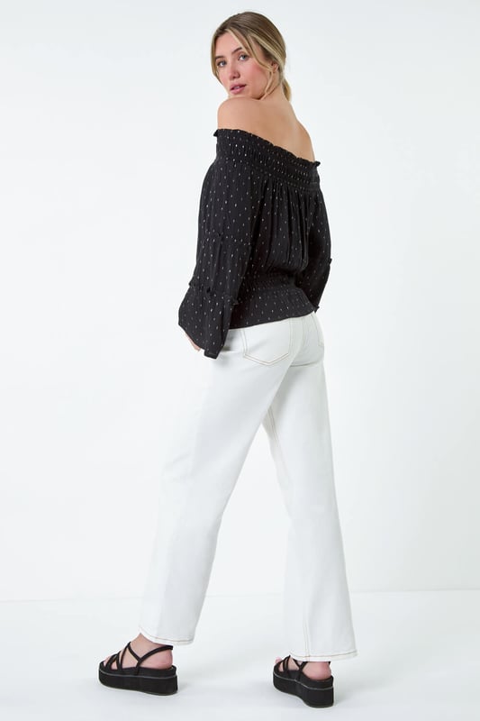 Shimmer Foil Textured Bardot Top from Roman. Shimmer into the new season with this metallic foil print bardot top. With its off-the-shoulder neckline and tiered sleeves, it exudes effortless Summer elegance. Made from a crinkle woven fabric, this top will keep you cool and comfortable on warm days with its relaxed bardot finish. The shirred stretch neck and waist provide a flattering fit, while the frill hem adds a feminine touch. Pair it with matching wide leg trousers (18061508) from our Dusk Collection for a chic and coordinated look or with denim jeans for casual Spring looks.