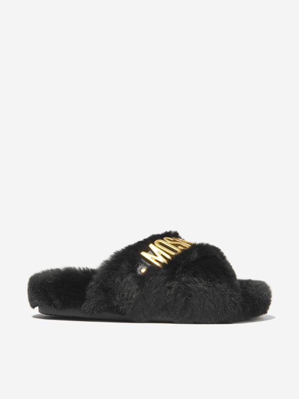 These Moschino Kids Girls Faux Fur Slippers add a touch of luxury to any wardrobe. Crafted from a soft blend of 88% Polyester and 12% Calf Leather, they feature a classic black hue, a furry surface and the iconic logo on the sides. Perfect for casual and formal occasions.·  Moschino Kids·  Made in Italy·  Occasion: Casual·  Print