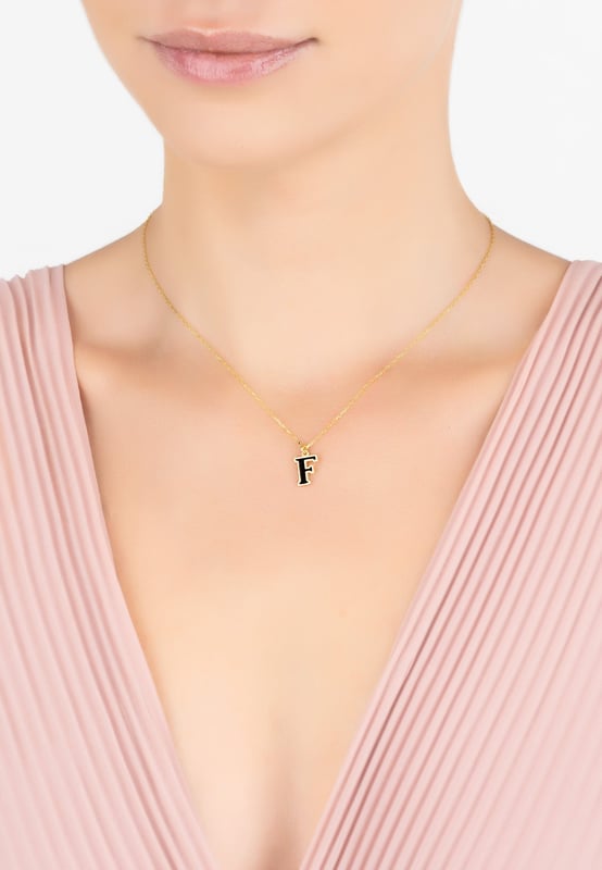 Design:This simple but beautifully styled initial enamel pendant necklace is perfect for those who covet delicate jewellery with a hint of colour, offering a sophisticated finishing touch to any outfit.Pretty and petite, this monogram necklace features a metallic setting with an inlay of black enamel. It looks perfect worn alone or, create your own unique style by layering with other necklaces.What can be more personal than a name? Give this initial pendant necklace as the perfect personalised birthday gift.Materials:Handcrafted using 925 sterling silver, dipped in 22ct gold. Black Enamel.Style Notes:Personalised birthday gift ideas. Bridesmaid gifts. Simple everyday styling.Dimensions:Necklace length 40cm with 5cm adjuster. Letter pendant length 1cm.Packaging:This item is presented in a Latelita London signature jewellery box.Care Instructions:To maintain your jewellery, wipe gently with a damp cloth that is soft and clean. Do not soak in water. Avoid contact with soaps, detergents, perfume or hair spray.