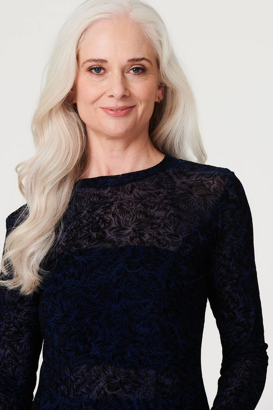 Stand out from the crowd in this delicate lace print peplum mesh top. With a high round neck, long sleeves, a high low hem and a sheer mesh fabric. Style with a cami top, high waist trousers and heels for an elegant evening look or be daring by layering over a bralette and high rise faux leather trousers and heels for cocktail hour.