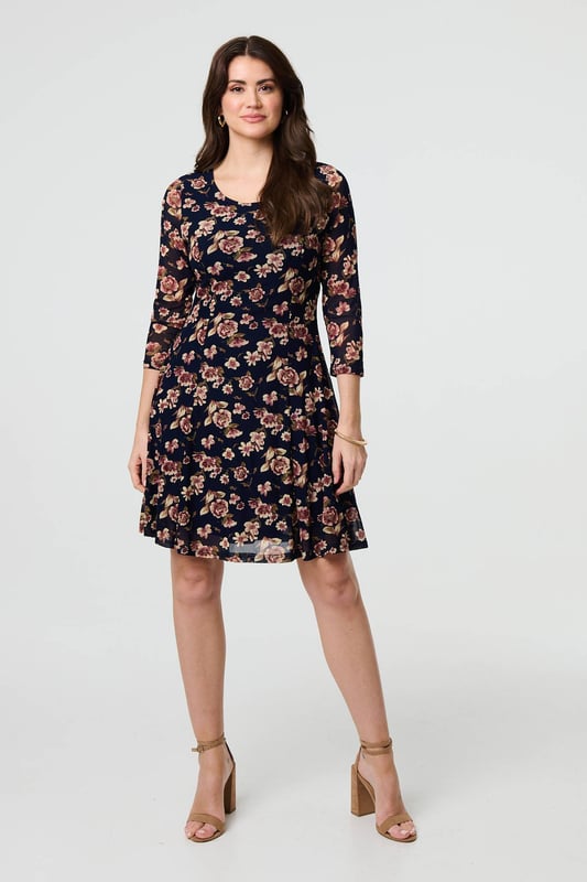 Navy Floral Sparkle Mesh Knee Length Dress You can never have too many floral dresses! This one has a feminine lace layer design, along with a flattering skater fit. It also features 3/4 sleeves, a scoop neck and a knee length hem. Wear with heels for a special occasion such as a wedding or a party.