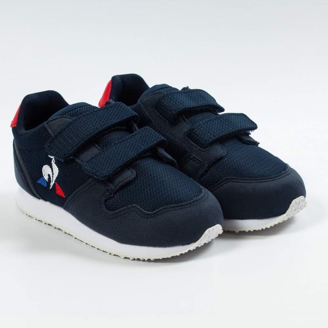 Basket Le Coq Sportif Jazy Inf Jungen Blau Textil. Authentischer Schuh von der Marke Le Coq Sportif - Streetwear/Sportswear Design von Le Coq Sportif - Le Coq Sportif für modebewusste Jungen, perfekt für den Alltag - Der blaue Basket Le Coq Sportif lässt sich ideal mit dem Rest deiner Garderobe kombinieren - Bequemes Textilmaterial - Klassischer Klettverschluss - Jazy Inf - Textil
