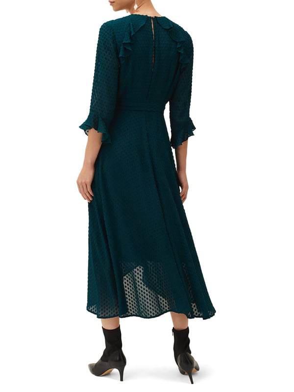 The Lilibeth Wrap Midi Dress in Ocean Blue offers timeless elegance with a modern twist, perfect for any casual occasion.