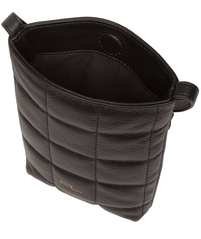 The 'Elouise' cross body phone bag from the Pure Luxuries Marylebone collection is handcrafted from high-quality, genuine Nappa leather with a natural super-soft touch. The eye-catching quilted design on the front gives the bag a unique silhouette, along with extra protection. A concealed magnetic closure keeps the contents of the bag secure. The interior is lined with 100% cotton and includes a slip pocket and two card slots. Comes with a matching and adjustable slim leather strap with a maximum drop length of 65cm. The minimalist Pure Luxuries logo is embossed in gold foil for a beautifully simple finishing touch.