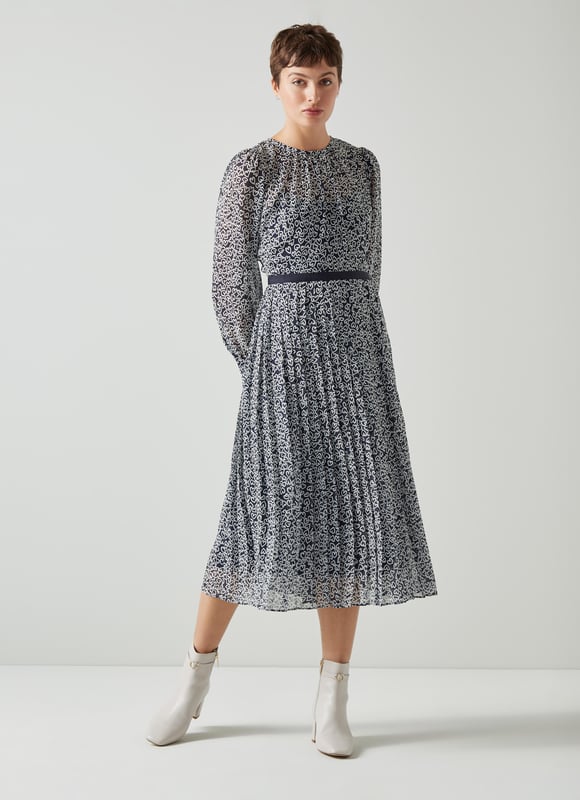 Playful prints are our thing, and when you team them with a great dress you simply can't go wrong (in our eyes). The new Estelle dress is crafted from a lightweight, slightly-sheer fabric in a navy and cream vintage archive heart print. It has a slip layer, a round neck with pleating detail, puff shoulders, long sleeves with pleated cuffs, a navy grosgrain ribbon waistband and a midi-length pleated skirt. Wear it with boots now and courts later - and remember to have fun in it.