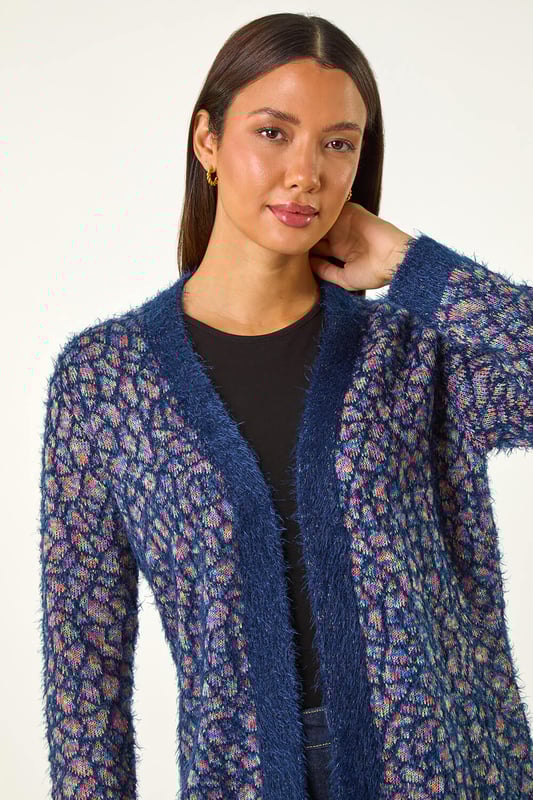 Mosiac Fluffy Trim Cardigan from Roman. Stay stylishly warm this Winter with our mosaic fluffy cardigan. This cosy piece features a unique mosaic design with a contrasting placket and cuff details, adding a touch of interest to your look. The long sleeves and secure edge to edge front provide extra warmth, while the longline length gives a flattering silhouette. Pair with a simple t-shirt and jeans for an effortlessly chic and cosy outfit.
