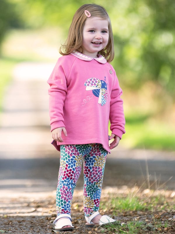 Come fly with me! Our ladybird sweatshirt is sure to brighten any day and is the perfect companion for days spent adventuring and exploring. Stylish and practical with a lovely ladybird ditsy appliqué on super soft pink lemonade brush back sweat fabric. Coconut button raglan sleeve opening up to and including size three years.