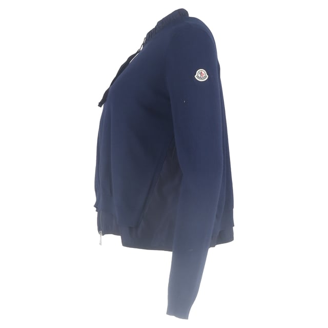 VINTAGE, RRP AS NEW
Add a touch of feminine sophistication to your wardrobe with the Moncler Ruffled Collar Zipped Cardigan in navy blue wool. This luxurious cardigan combines modern design with classic comfort, crafted from soft, breathable wool that provides warmth and a cozy feel, while the rich navy blue hue offers timeless versatility.

 Moncler Ruffled Collar Zipped Cardigan in Navy Blue Wool

Condition: Excellent
Signs of wear: No retail tag but Brand tag on., No visible sign of wear., 
Packaging: None
Color: Blue | navy blue
Material: Wool
Size: INT | L/UK14/IT46/US10/FR42
Measurements: Length: 550
SKU: NAPPUGBCL444354W
