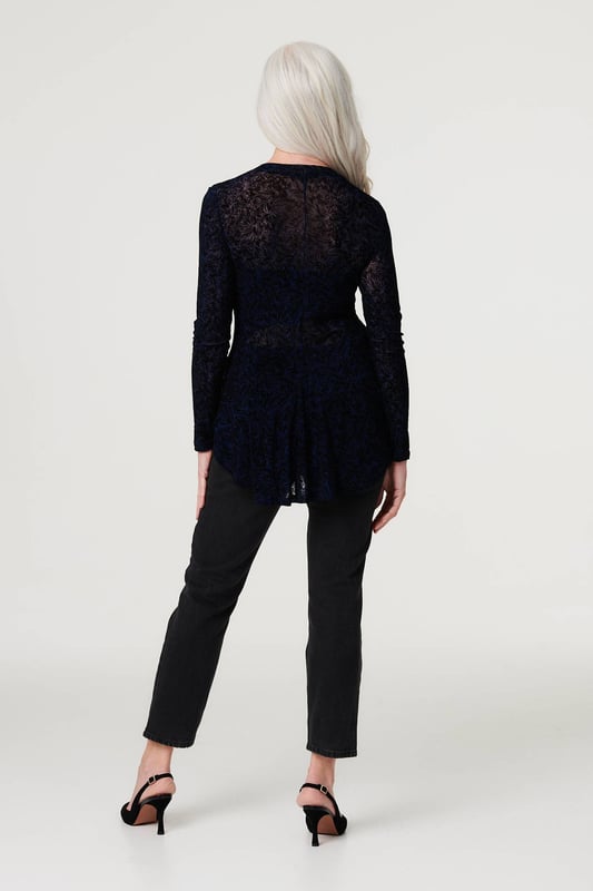 Stand out from the crowd in this delicate lace print peplum mesh top. With a high round neck, long sleeves, a high low hem and a sheer mesh fabric. Style with a cami top, high waist trousers and heels for an elegant evening look or be daring by layering over a bralette and high rise faux leather trousers and heels for cocktail hour.