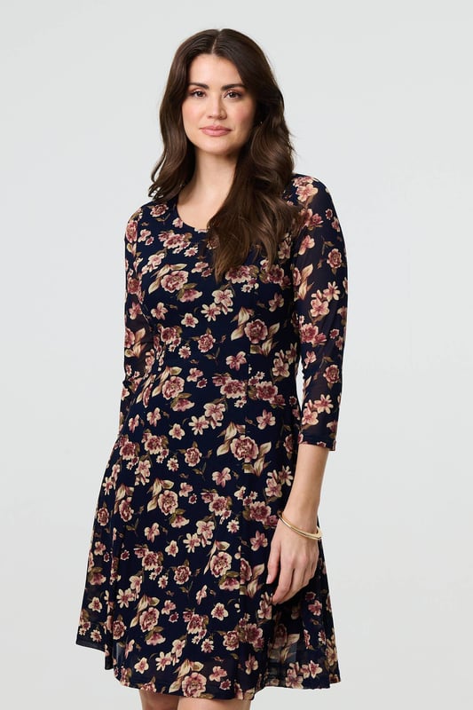 Navy Floral Sparkle Mesh Knee Length Dress You can never have too many floral dresses! This one has a feminine lace layer design, along with a flattering skater fit. It also features 3/4 sleeves, a scoop neck and a knee length hem. Wear with heels for a special occasion such as a wedding or a party.