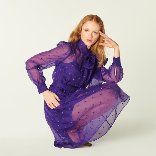 A vibrant play on our vintage-inspired Glinda pieces, Depp takes on the spotty organza in striking violet. Crafted from fine silk organza in purple dotted with purple embroidered spots, this long-sleeve dress has a round neck finished with an oversized bow, a slip layer, a nipped waist and a full skirt. Wear it with sharp courts and a clutch when those dressing up moments call.