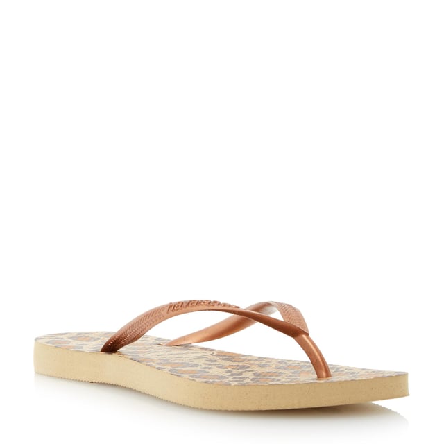 Create a glam beachside look in Havaianas' snake print design. Black, lilac and rose with metallic straps and slight wedge sole. Made in Brazil with non-slip finish, heat and water resistant.