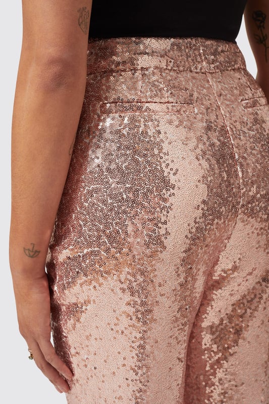 The Caladium Trouser in Rose Gold is a go-to party and event favourite. Adorned with shimmering sequins, It's guaranteed to turn heads as soon as you enter the room. Cut to a slim fit with a flared leg, it's the perfect pair of trousers with a rose gold twist. Pair it with the matching Caladium Jacket in Rose Gold to complete the full look.