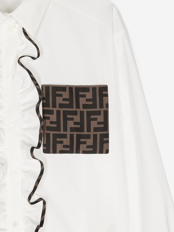 Fendi encapsulate passion and meticulous energy in their beautifully crafted Italian portraits. This girls blouse embodies the label's unparalleled high quality and innovation. It showcases a Zucca monogram detail and ruffle printed trims down a front button fastening. 100% Cotton