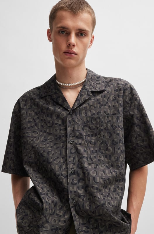 short sleeve shirt - reverse lapels - button closure - poplin - allover print - tag print - animal metal stacked logo - small metal stacked HUGO logo - RESPONSIBLE.A statement shirt in an oversized fit by HUGO Menswear. Designed in breathable cotton poplin  this short-sleeved piece is printed with a seasonal motif.