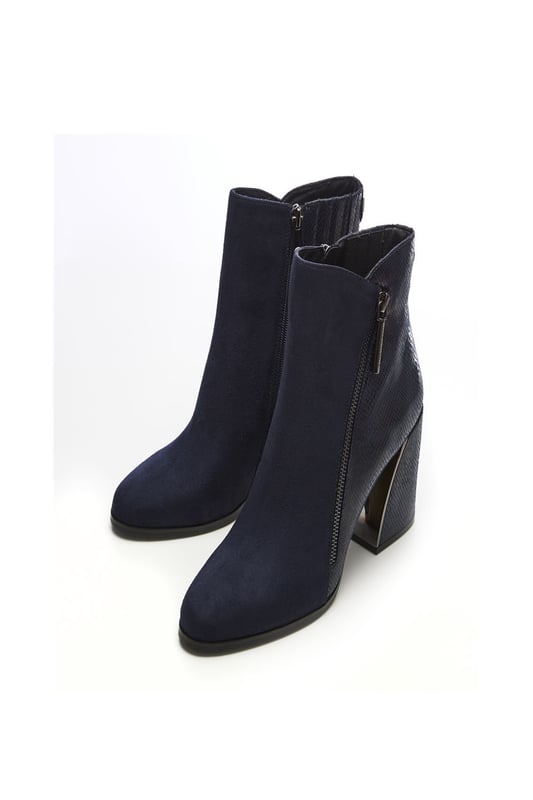 Your new favourite wide fit boot. Amy features a stunning curved block heel with a metallic inner, the contrasting textures on the shoe add further detail whilst still leaving it effortless to style. Complete with a functional inside zip and a decorative outside zip. Style with leather trousers and a blouse.