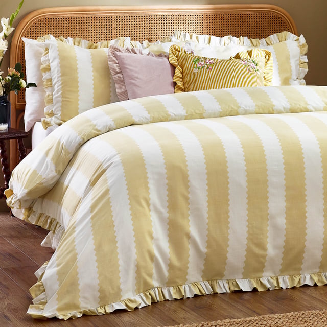 Bring a touch of elegance to your bedroom with the Birdie Stripe Ruffle Duvet Cover Set. Crafted from cotton-rich fabric with a 180 thread count, this duvet cover set offers a blend of comfort and style. The delicate ruffle trim nods to British heritage while adding a subtle hint of cottagecore charm. Its reversible design features classic stripes on both sides, offering versatility to match your décor. Designed for those who appreciate classic prints and patterns, this timeless bedding will become the centrepiece of your room, creating a serene retreat inspired by the natural world. 200 x 200cm