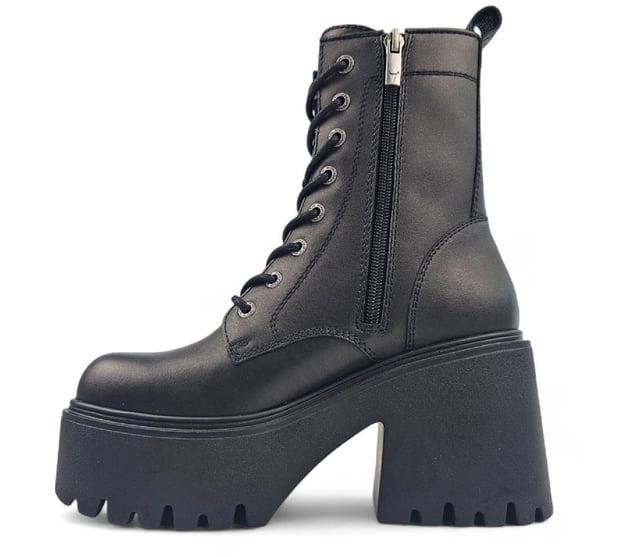 Step into bold fashion with the Totally Black Platform Boots, designed to make a statement with every stride. These chunky lace-up boots feature a robust black leather upper that exudes confidence and style. The round toe design and eye-catching bull symbol on the upper add a unique flair, while the inside zipper ensures easy wear.

Key Features:

Chunky Heel and Platform: A striking heel height of 9 cm combined with a 4.6 cm platform gives you an elevated look without sacrificing comfort.
Durable Black Leather Upper: Crafted from high-quality black leather, these boots provide both style and durability for everyday wear.
Lace-Up Design: The adjustable lace-up feature allows for a customizable fit, ensuring both comfort and security.
Cleated Sole: The cleated sole provides excellent grip and traction, making these combat boots perfect for any terrain.
Non-Leather Lining: Designed with a non-leather lining for enhanced breathability and comfort during all-day wear.
Whether you're dressing up for a night out or adding edge to your casual look, the Totally Black Platform Boots are the perfect blend of style and practicality. Embrace your inner warrior and make every outfit a bold fashion statement!