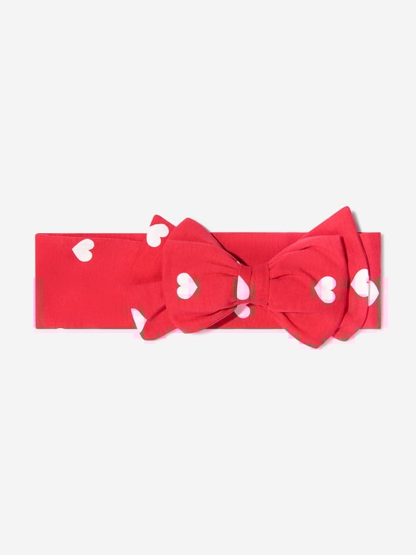 Finish off their look with this pretty red cotton jersey headband by luxury brand, Monnalisa. With a scattering of white hearts this soft and stretchy features a large fixed bow on the front.
