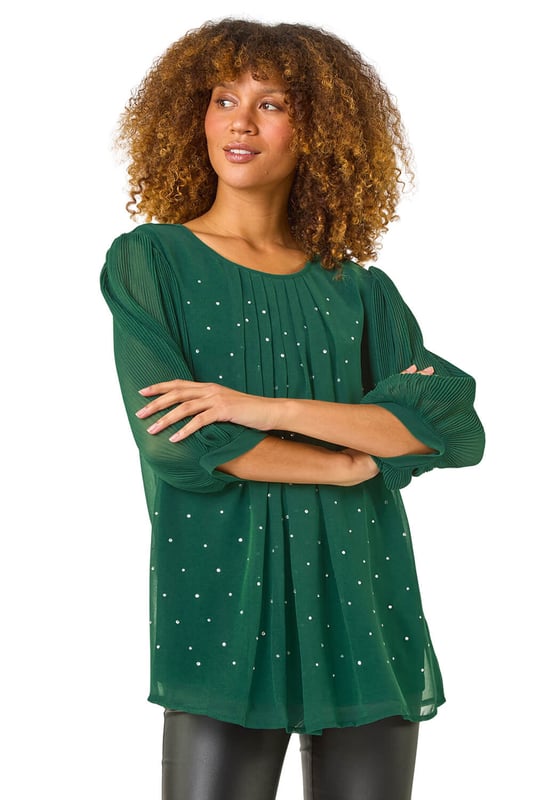 Pleated Sleeve Hotfix Detail Top from Roman. Add a touch of glamour to your Autumn/Winter wardrobe with this chic pleated sleeve top. The stylish round neck and elegant gathering at the neckline perfectly complement the eye catching all over hotfix detailing. The 3/4 pleated sleeves add a feminine touch to this versatile top. Pair it with pleather trousers and heeled boots for a party ready look that's sure to make a statement!