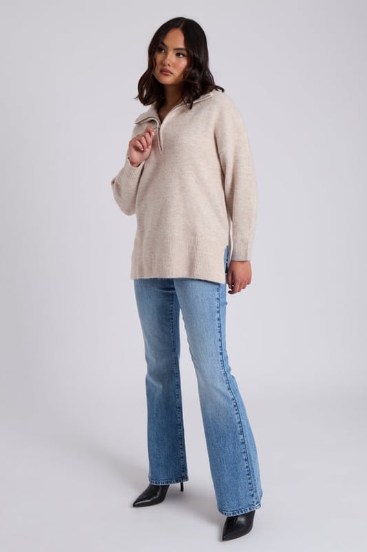 Model is 5'6 and wears a size 8. Crafted with utmost attention to detail, the Oatmeal Plain Oversized Half Zip boasts a relaxed and flattering oversized fit that drapes elegantly, providing a cosy and stylish look for any occasion. Its soothing creates a sense of sophistication, making it a timeless piece that can effortlessly transition from season to season.