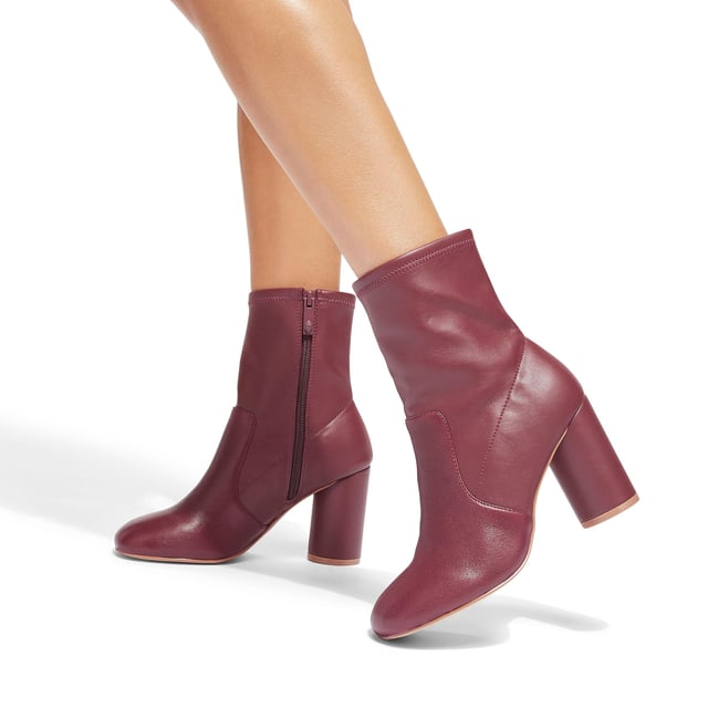 This Langley Round Ankle Boot features a wine upper crafted from a soft leather. The heel is rounded matching the toe shape. Heel height: 9cm.