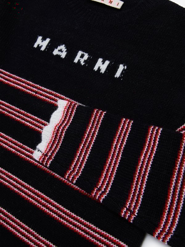 Introducing the Girls Knitted Striped Dress in Black by Marni, the epitome of high-end style for AW2024. Meticulously crafted for the chic young girl's wardrobe, experience the synthesis of luxury and playful elegance. Exquisite Craftsmanship: Precision knitting from luxury yarns ensures durability and aesthetic appeal. Bold Stripes: Classic black stripes introduce a timeless, fashionable edge to any occasion. Soft and Comfortable: Ultra-soft fabric guarantees all-day comfort, perfect for both special events and casual outings.Elevate your child's fashion game with Marni's Striped Dress in Black. A standout addition for any young fashionista's collection.
