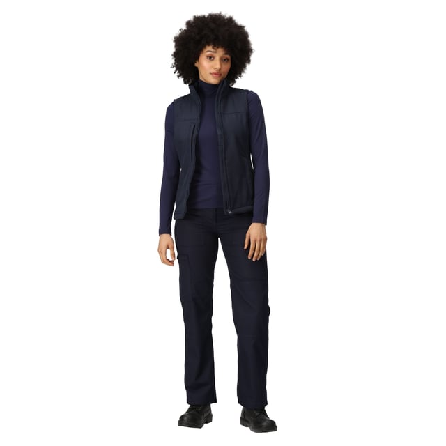 Material: 96% Polyester, 4% Elastane. Fabric: Soft Touch, Softshell, Stretch, Woven. 270gsm. Design: Plain. Fit: Shaped. Quick Dry, Water Repellent, Wind Resistant. Fabric Technology: Warm-Backed. Sleeve-Type: Sleeveless. Neckline: Zip. Pockets: 2 Lower Pockets, 1 Chest Pocket, Zip. Fastening: Zip. Hem: Adjustable, Shockcord Hem.