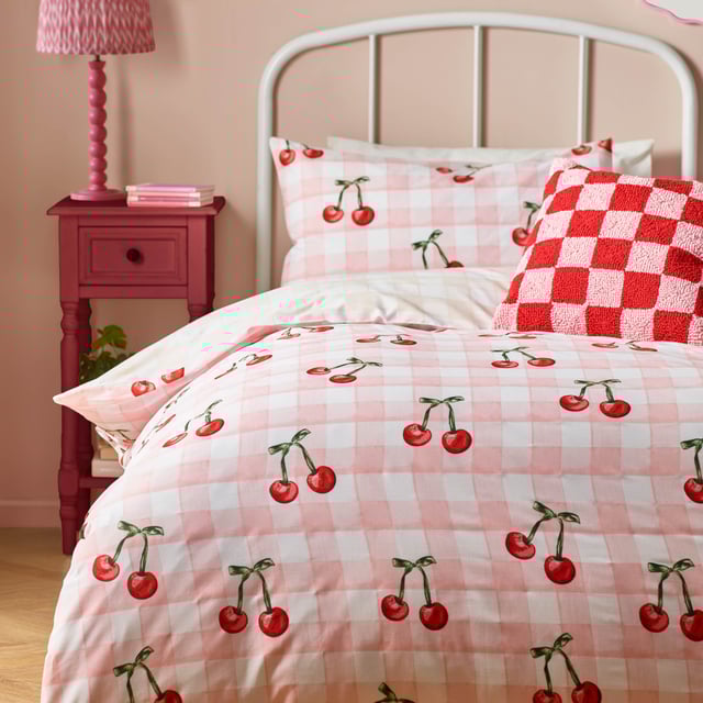 Introducing the Cherry Gingham Duvet Cover Set—a delightful blend of classic charm and modern flair perfect for those who cherish individuality. Crafted from high-quality 68 Pick Polycotton, this reversible duvet cover promises comfort and style in equal measure. The timeless gingham pattern is playfully adorned with bold red cherries, adding a touch of whimsy to your bedroom decor. Whether you're a positive thinker or someone who values unique self-expression, this bedding invites you to create a personal sanctuary that reflects your vibrant personality. Experience the joy of modern design with a touch of tradition, ensuring restful nights and chic aesthetics.