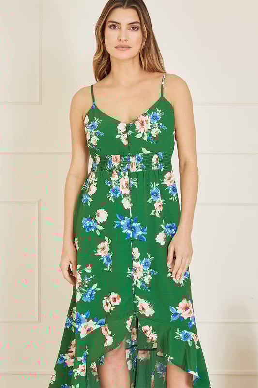 Spring in to summer in this gorgeous strappy midi dress from Mela. In an all over in house design floral print, with a ruched waistline, button details and that stunning flowy dip hem. Perfect for strolls on a beachfront, or those high summer wedding invites!