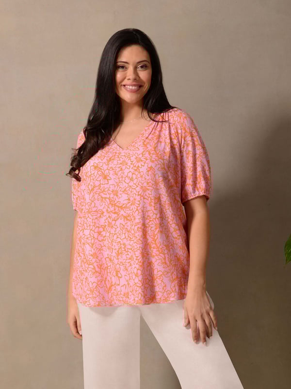 Details

Stand collar with placket
Short sleeve with elastic cuffs
Slips on

Garment Care

Composition: 100% Viscose
Machine washable  

Sizing

Model height: 5ft 10inches/178cm
Length from back neck to hem: 68cm

In a stylish orange and pink print, this short sleeve blouse is cut from a lightweight woven fabric. It has a lengthening nehru collar, as well as short sleeves with elasticated cuffs to keep you cool in warmer weather. An A-line shape and slightly rounded hem make for a flattering fit, making this the perfect daytime blouse.