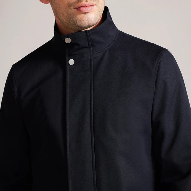 Men's Ted Baker Erolson Funnel Neck Coat in Navy.- Funnel neck.- Zip and popper fastening.- Pockets.- Removable quilted lining.- Mid-length.- Material: 100% Polyester. Ref: 272518NAVY.