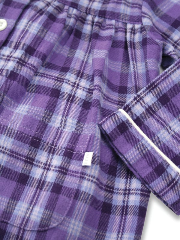 Girls Lilac and Purple Check Traditional Winter Pyjama Set. 

A timeless check is given the Mini Vanilla touch using lilac and purple tones in our kids pyjama set. Made from super-soft and cosy, brushed 100% cotton, the PJ set is trimmed in white cotton. The long-sleeved top has an open collar and fastens with engraved buttons. Fully elasticated at the waist the trousers have a comfy fit.

Our pure-cotton check pyjamas are a beautiful-quality addition to their nightwear collection. Our cotton flannel is brushed, making it unbeatably soft and cosy against the skin and plush to the touch. A great PJ gift for girls too!

Features
Button-through long-sleeved top
Classic Brushed Check Fabric
Contrast piping along collar and cuffs
Elasticated waistband
100% soft brushed Cotton
Machine Washable
Front pockets
Engraved pearl effect buttons
