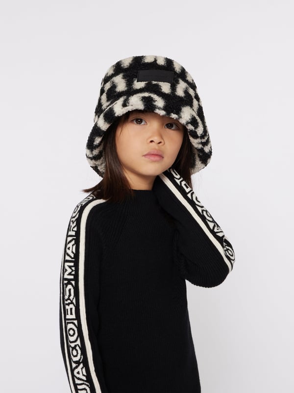 Introducing the Kids Faux Shearling Bucket Hat in Black by marc_jacobs, essential for AW2024. This chic accessory promises style and warmth for both boys and girls. Discover its standout features:‚ Luxurious Faux Shearliner: Offers a plush feel and maximum warmth.‚ Signature Black: Versatile and classic, complements any outfit.‚ Designer Craftsmanship: marc_jacobs's attention to detail ensures durability.Elevate your child's wardrobe with this stylish piece. Shop now to add a touch of elegance to their cool-weather look!