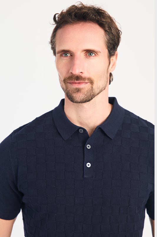 This textured polo shirt from Nines Collection blends classic sophistication with modern design. Crafted from a premium cable fabric with a subtle pattern, it offers a refined yet contemporary look. Lightweight and breathable, it’s a versatile choice for smart-casual occasions, ensuring style and comfort effortlessly. Made from 100% Cotton.