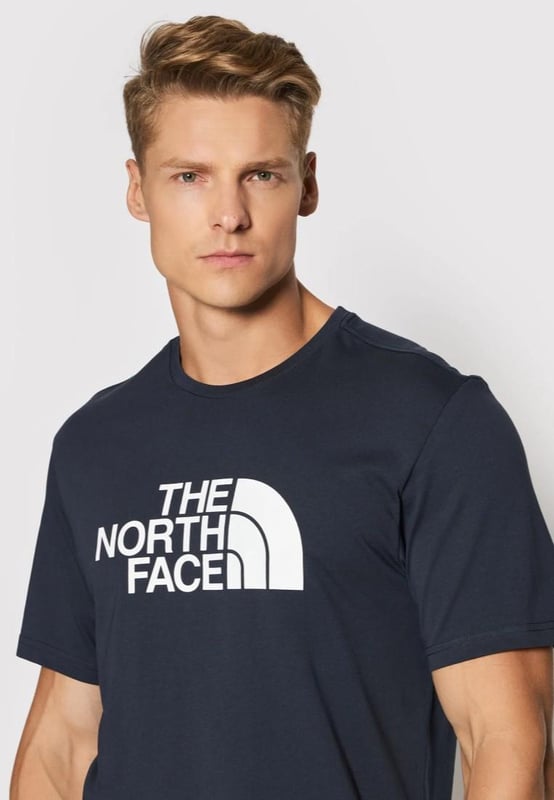 The North Face Mens Short Sleeve Easy Tee.     
Pressed Plastisol Print at Front.     
The North Face Logo on the Back of the Shoulder.     
Classic Length Short-sleeve T-shirt With Crew Neck.      
100% Cotton.     
Machine Washable (Please See Care Label).     
The North Face Mens T Shirt TNF Short Sleeve Crew Neck Cotton Casual Easy Tee.