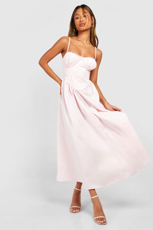 Sweetheart neckline for a feminine touch
        Adjustable spaghetti straps for a customised fit
        Fitted bodice with ruched detailing
        Flowy midi-length skirt for effortless movement
        Versatile design suitable for various casual occasions
    
    This charming midi dress from Boohoo is the perfect addition to your summer wardrobe. The sweetheart neckline and ruched bodice create a flattering silhouette, while the flowy skirt adds a touch of romance to your look. Style it with strappy sandals and a woven bag for a laid-back daytime ensemble, or dress it up with wedges and statement earrings for a garden party. The adjustable straps ensure a comfortable fit, making it ideal for long days out or family gatherings. This dress embodies the carefree spirit of summer, allowing you to look effortlessly chic whether you're brunching with friends or attending a casual outdoor event. Its versatility makes it a wardrobe staple that you'll reach for time and time again.