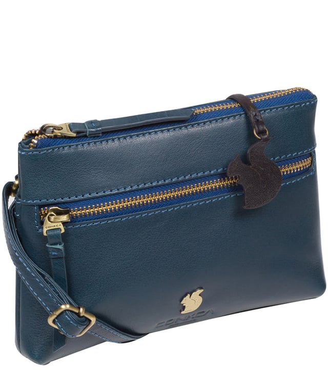 The 'Sweetie' cross body bag from Conkca London is handcrafted from multi-toned leather for a beautiful finish. A zip-over top opens to reveal a spacious yet compact main compartment with two slip pockets, lined with natural and untreated 100% cotton. Features a zipped pocket on the front and a slip pouch on the rear, ideal for on-the-go storage. Comes with an adjustable leather strap with a maximum drop length of 70cm. Adorned with the inimitable Conkca squirrel charm and Conkca logos.
