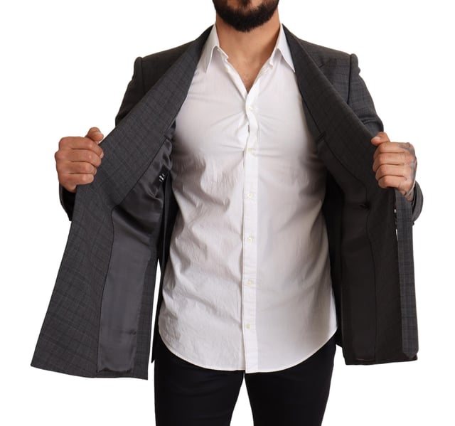 Brand: Dolce & Gabbana
  Model: MARTINI
  Style: Double breasted one button
  Fitting: Slim fit
  Color: Gray check
  Three outside pockets and two inside pockets
  One open vent in the back
  Logo details
  Made in Italy
  Material: 99% Wool 1% Elastane
  Lining: 100% Silk
Material: 99% Wool 1% Elastane