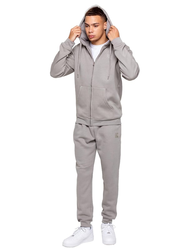 Elevate your everyday look with the Kruze Men’s Tracksuit Set, a perfect blend of comfort, warmth, and style. This set includes a regular-fit zip-up hoodie and matching joggers, both crafted with a cozy brushed-back inner fleece for a soft feel and added insulation on cooler days. The hoodie features an adjustable drawstring hood, ribbed cuffs and hem for a secure fit, and Kruze’s rubber-printed branding on the chest for a touch of signature style. Two convenient side pockets offer space for your essentials. Paired with regular-fit joggers, this tracksuit ensures all-day comfort and a sleek look. The joggers come with a ribbed waistband and adjustable drawstring for a tailored fit, two side pockets for practicality, and ribbed ankles for a streamlined, modern silhouette. A Kruze rubber print on the leg adds subtle branding.